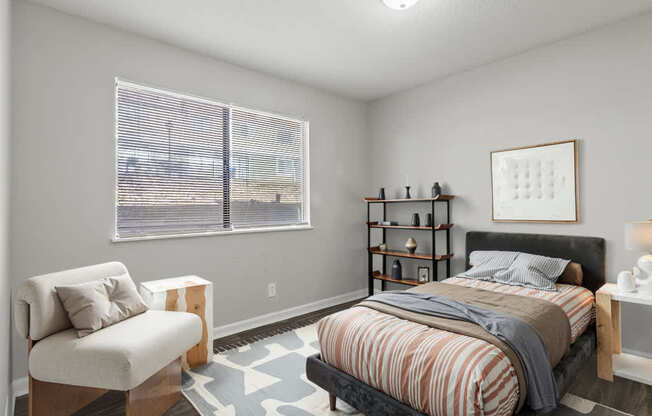Element at 4411 Macon Apartments A bedroom with a bed, chair, and shelves.