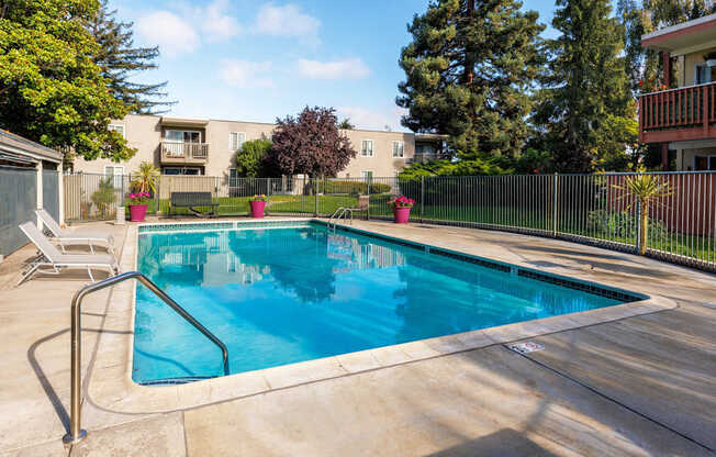 A small pool with a metal fence around it.