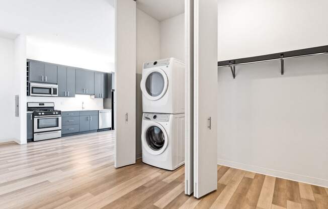 a washer and dryer in a living room with a kitchen