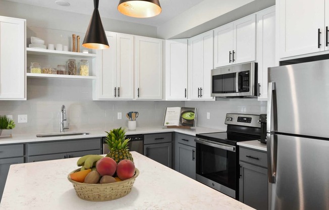 a kitchen with stainless steel appliances and white cabinets