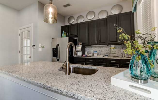 a kitchen with a sink and a refrigerator