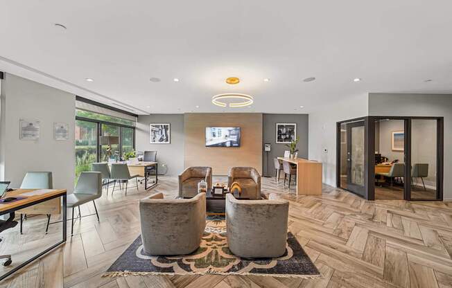 A modern living room with a flat screen TV and a wooden floor.