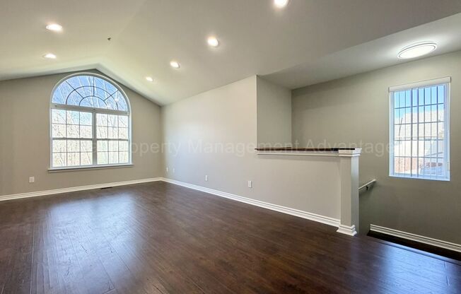 Rare Corner Upper Condo with Vaulted Ceilings, Private Balcony and 2 Car Garage - Right Across from the GM Tech Center!