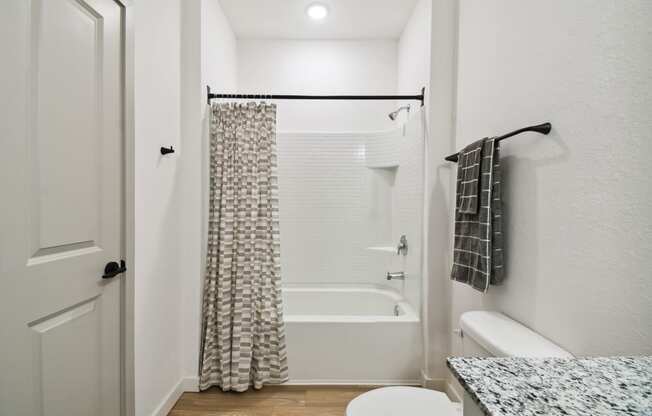 a bathroom with a shower and a toilet and a shower curtain at Gibson Oaks, Lakeland, 33809