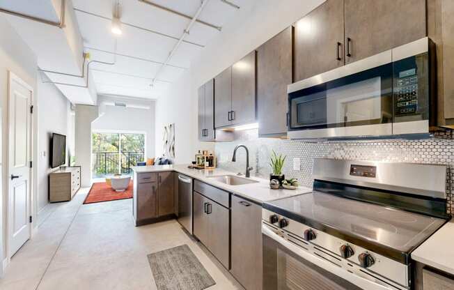 a modern kitchen with stainless steel appliances and wooden cabinets