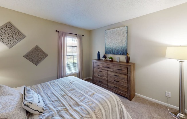 a bedroom with a bed and a window