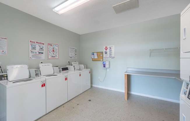 the laundry room is equipped with washes and dryers and a counter with a