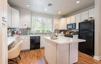 A kitchen with black appliances and white cabinets.at Palazzo Townhomes, Phoenix, AZ 85008  