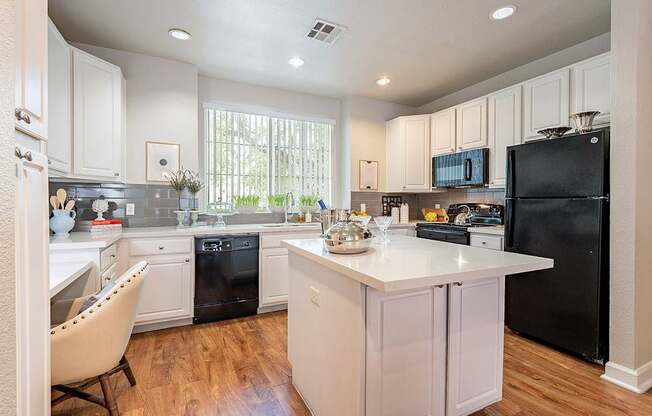 A kitchen with black appliances and white cabinets.at Palazzo Townhomes, Phoenix, AZ 85008  