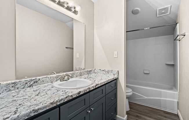 a bathroom with a sink and a shower and a mirror at Diamond Ridge Townhomes, Oklahoma City Oklahoma