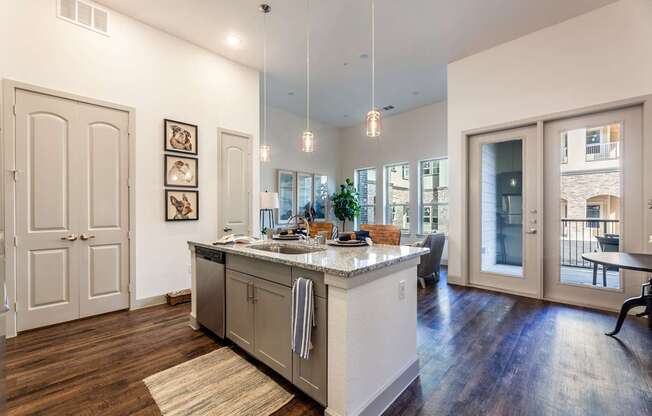 A kitchen with a marble countertop and a view of the city.