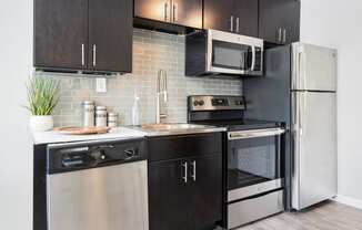 a kitchen with modern cabinets and stainless steel appliances