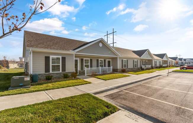 a row of houses on a street with a parking lot