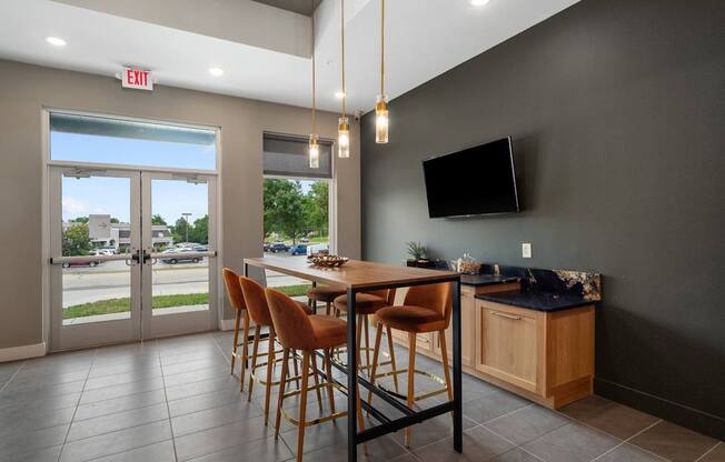 A modern dining room with a wooden table and chairs.