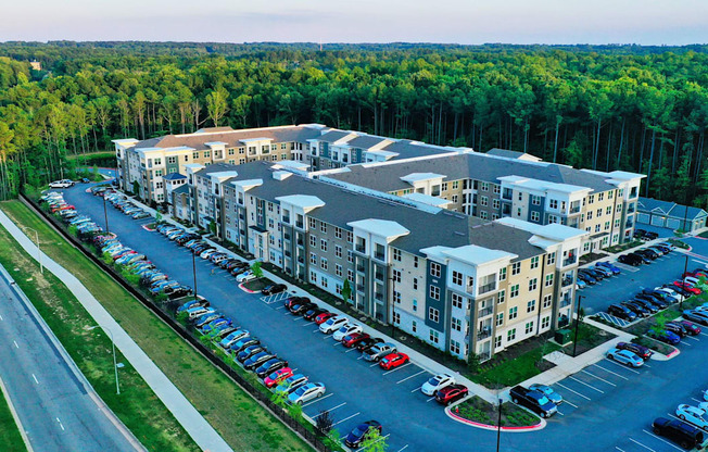 A large building with a parking lot in front of it.