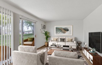 a living room with a couch and chairs and a television