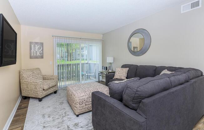 a living room filled with furniture and a flat screen tv