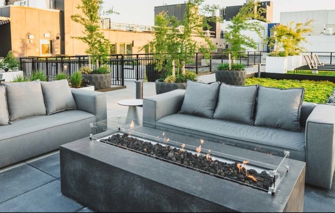 Cozy up to mountain views at Modera Broadway's rooftop fire pits and lounge areas
