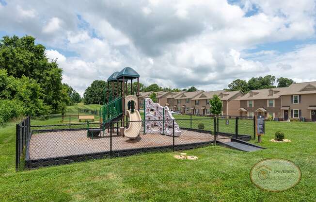 a playground with a jungle gym and a swing set in a park