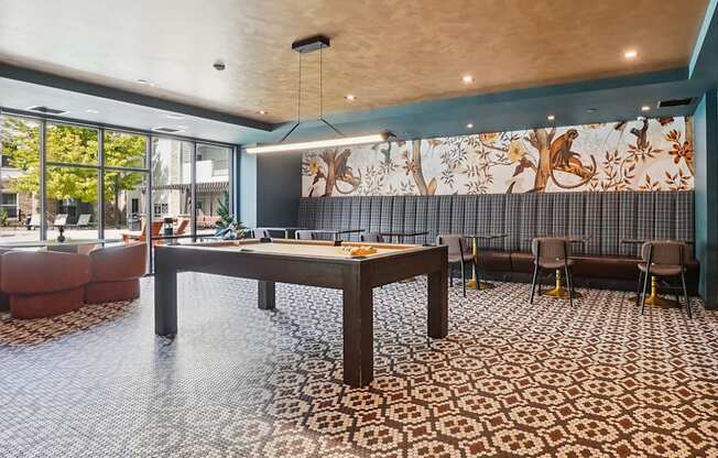 A room with a patterned carpet and a large table with chairs.