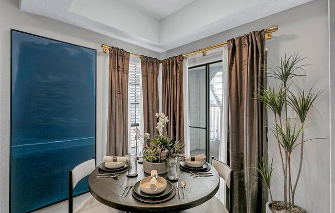 a dining room with a table and chairs and a large window