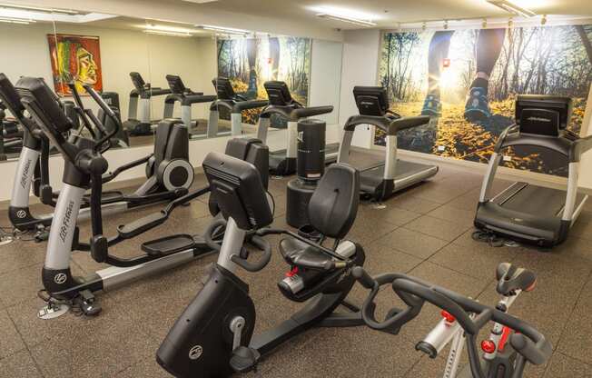 a group of exercise bikes in a gym