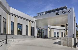 The image shows a modern building with the name "CRatio" on it.