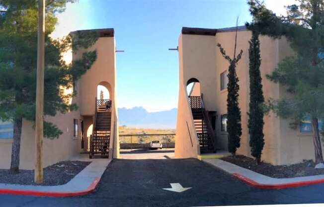 A building with a red arrow painted on the pavement in front of it.