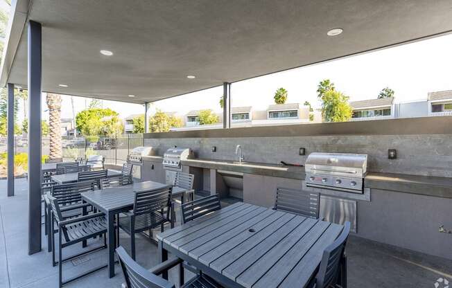 A patio with a grill and seating area.