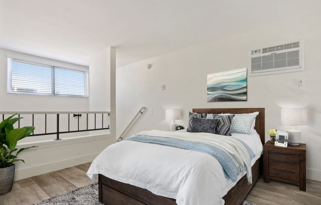 Sleeping area of an executive loft with wood inspired floors