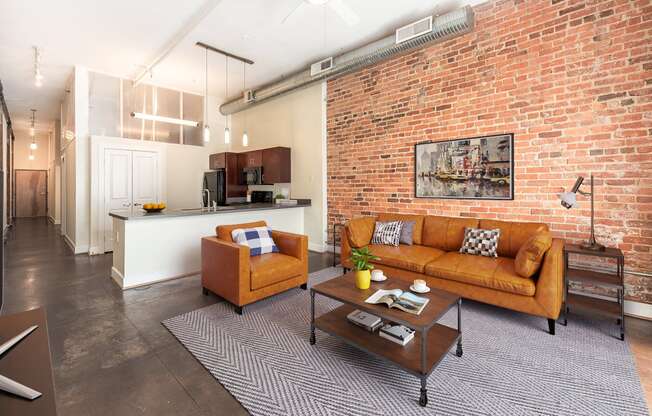 a living room with a brick wall and a couch