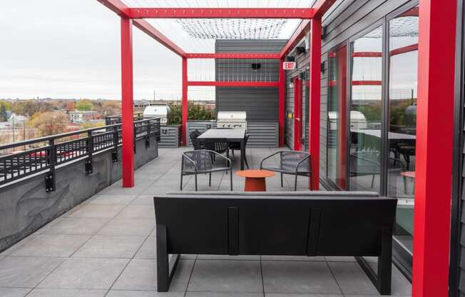 a terrace with tables and chairs on a roof