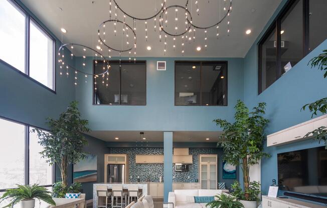 Bright lounge with large windows, open seating, and modern lighting that enhances the airy layout.