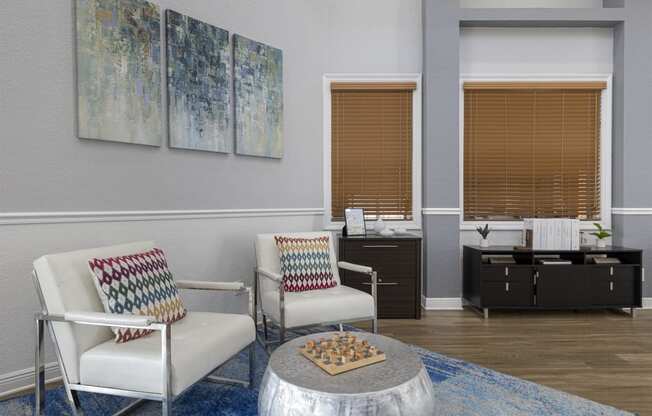 a living room with two chairs and a table with a chess board