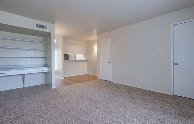 a bedroom with a white wall and a carpeted floor
