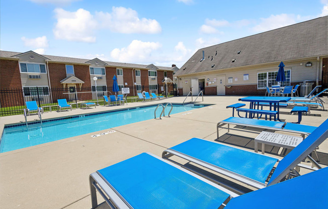 our apartments have a large pool with tables and chairs