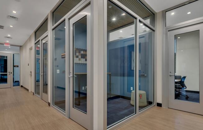 a corridor with glass doors and a wood floor