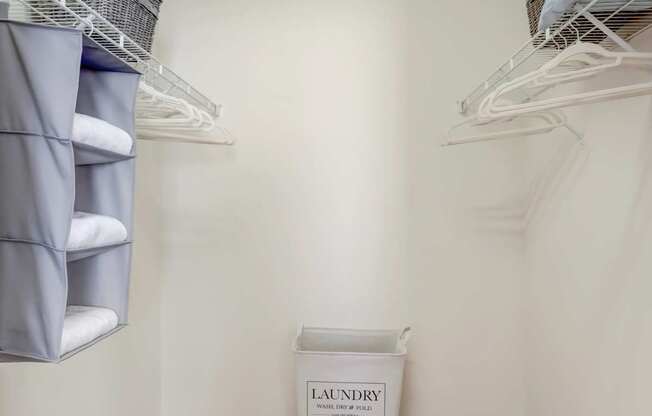 Laundry basket in a small room with a carpeted floor.