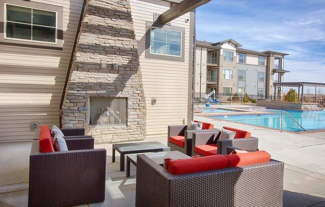 Outdoor Poolside Lounge with Chairs and Fireplace