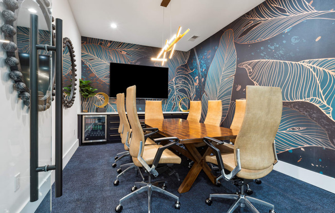 a conference room with a wooden table and chairs and a large screen tv on the wall