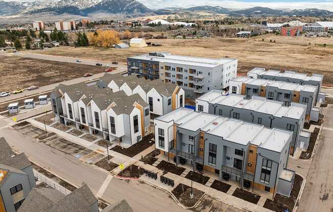 A large building complex with a parking lot in front of it.