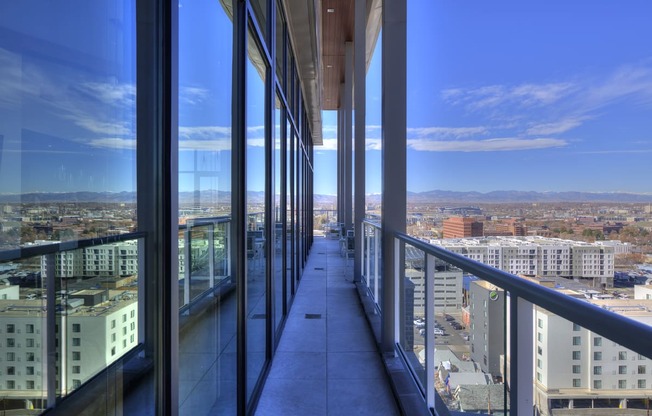 Sky lounge balcony, with concrete pillars and walkway and glass railing