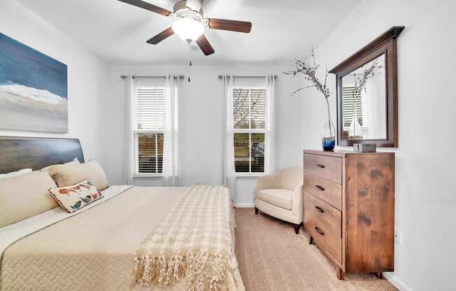 a bedroom with a bed and a ceiling fan