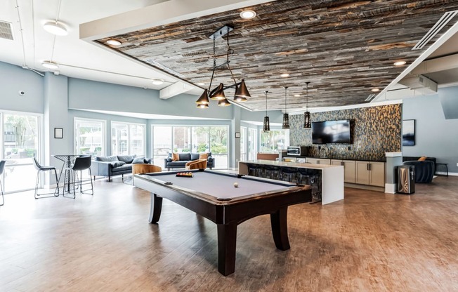 a game room with a pool table and a tv
