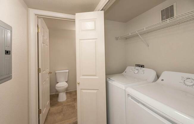 A white bathroom with a toilet, sink, and towel rack at Autumn Oaks Apartments, Roseville, CA, 95678