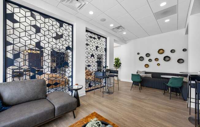 a lounge area with couches and chairs and a table with chairs in a lobby