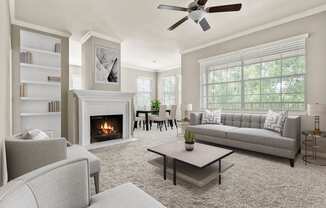 a living room with couches and chairs and a fireplace at Villages of Cypress Creek, Texas