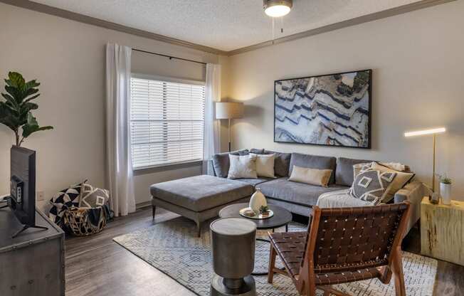 a living room with a couch and a tv at Lakeshore at Preston, Plano, Texas