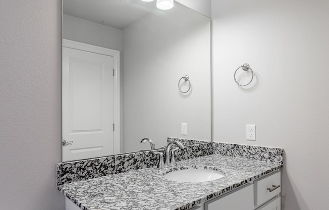 a bathroom with a sink and a mirror