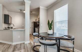 A dining area with a table and chairs.